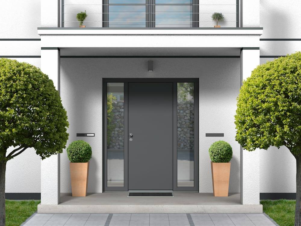 house facade with entrance portal, balcony, pillars and front door